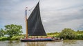 Traditional Norfolk wherry Albion sailing down the River Bure in Horning, UK Royalty Free Stock Photo